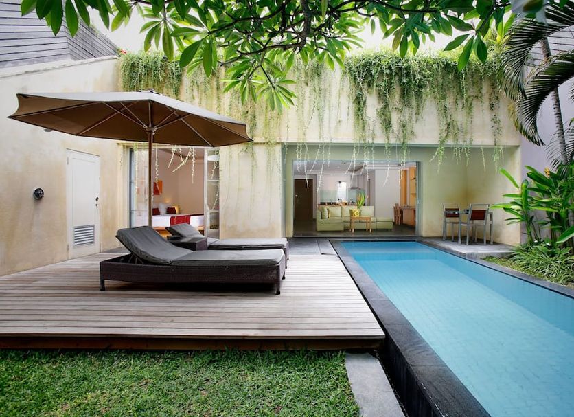 Bali Island Villas and Spa Seminyak in Kuta: private pool, lounge chairs and patio with tropical greenery