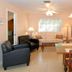 Seahorse Cottages on Sanibel living room with sofa, armchairs, dining table, and TV