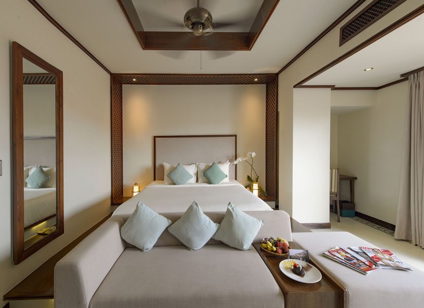 Almanity Hoi An Resort & Spa in Hoi An guest room with bed, daybed, and seating area