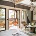 Jumeirah Dar Al Masyaf Dubai suite with terrace access, sofa seating, and balcony palm views