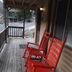 Evening Shade River Lodge & Cabins porch with red rocking chairs in Chimney Rock
