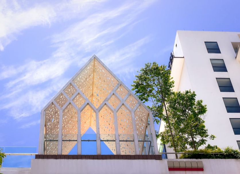 Ucsi Hotel Kuching in Kuching with a glass pavilion and white building against a blue sky