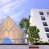 Ucsi Hotel Kuching in Kuching with a glass pavilion and white building against a blue sky