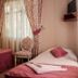 Dalyan Terrace Hotel in Dalyan, Mugla room with two single beds, floral curtains and a chair