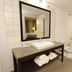 Country Inn & Suites by Radisson, Crystal Lake, IL bathroom with vanity, mirror, tub, and toilet