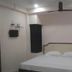 Abirami Inn, Kumbakonam: simple hotel room with double bed, wall-mounted TV and ceiling fan