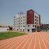Sai Sangam Hotel in Shirdi with striped driveway, landscaped lawn, and exterior building view