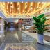 East Queen Hotel Lanzhou Taohai Branch lobby in Lanzhou with marble floors, warm ceiling lights and seating