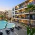 BS Residence Suvarnabhumi in Bangkok with a courtyard pool and balconies at sunset
