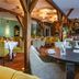Hotel & Spa Savarin in Rijswijk restaurant with timber beams, set dining tables, and warm lighting