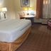 La Quinta Inn & Suites by Wyndham Sawgrass in Sunrise guest room with king bed, desk, and window seating
