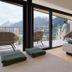 Hotel Kirchenwirt in Kaunertal room with balcony and mountain view, featuring a bed and seating area.