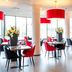Bastion Hotel Dordrecht Papendrecht restaurant with red pendant lights and tables by large windows
