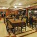 Hotel Mahabs in Mahabalipuram restaurant dining room with set tables and warm wood-paneled interior
