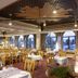 Lapland Hotels Riekonlinna in Saariselka dining room with large arched windows and set tables
