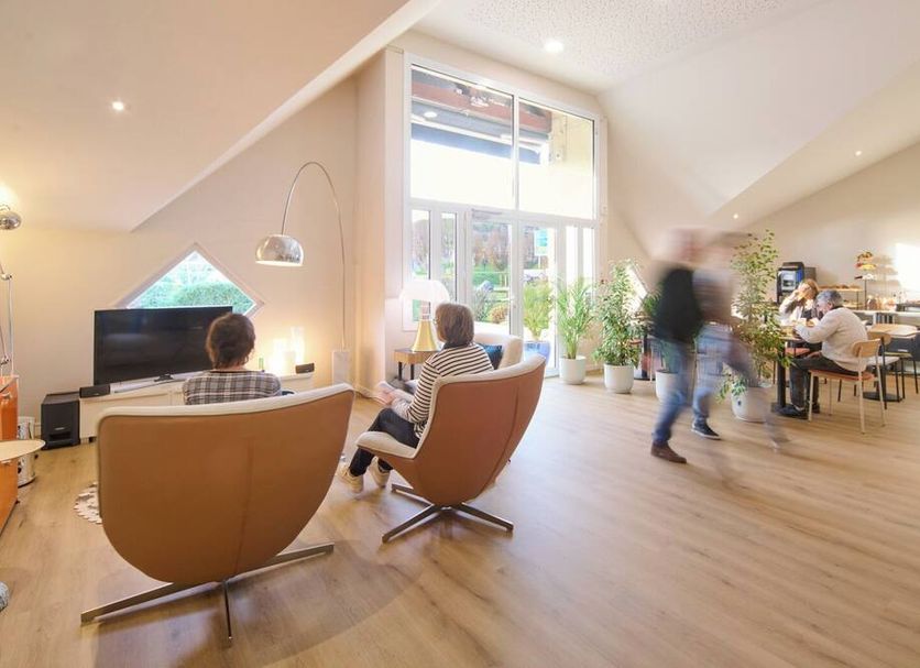 Le Clos Mouron in Tournus lounge with TV, chairs, dining tables and large windows