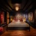 Palma Riad in Palma de Mallorca, five-star room with ornate floral headboard and dark dramatic decor