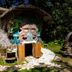 Hotel Villa Mercedes Palenque in Palenque, tropical hut-style exterior with carved face and stone fire pit