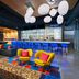 Aloft Waco Downtown in Waco: colorful lounge with bar, blue stools, and bright modern seating