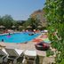 Nur Apart in Marmaris: outdoor pool with sun loungers, umbrellas, and guests relaxing in the water
