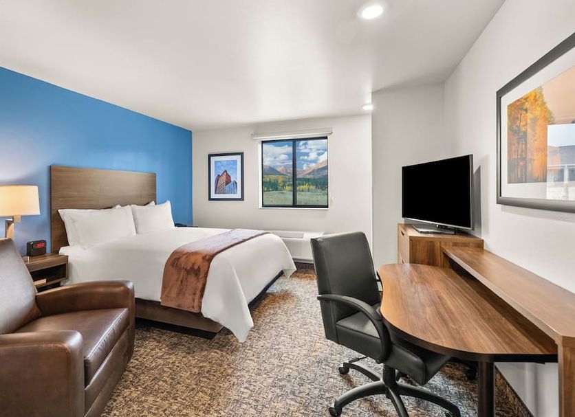 My Place Hotel-Colorado Springs, co room with bed, chair, desk, TV and mountain view