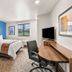 My Place Hotel-Colorado Springs, co room with bed, chair, desk, TV and mountain view