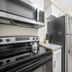 Riverwatch Apartments By Lowkl kitchen with stainless steel appliances and dining table in Jensen Beach