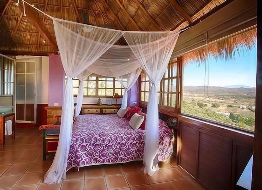 Villa Bella Bed & Breakfast Inn in La Cruz de Huanacaxtle bedroom with canopy bed and valley view