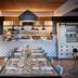 Dining area at The Casso, Raleigh, a Tribute Portfolio Hotel with open kitchen and long communal table