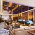 The Longemont Shenyang lobby with lounge seating, reception desk and mirrored ceiling