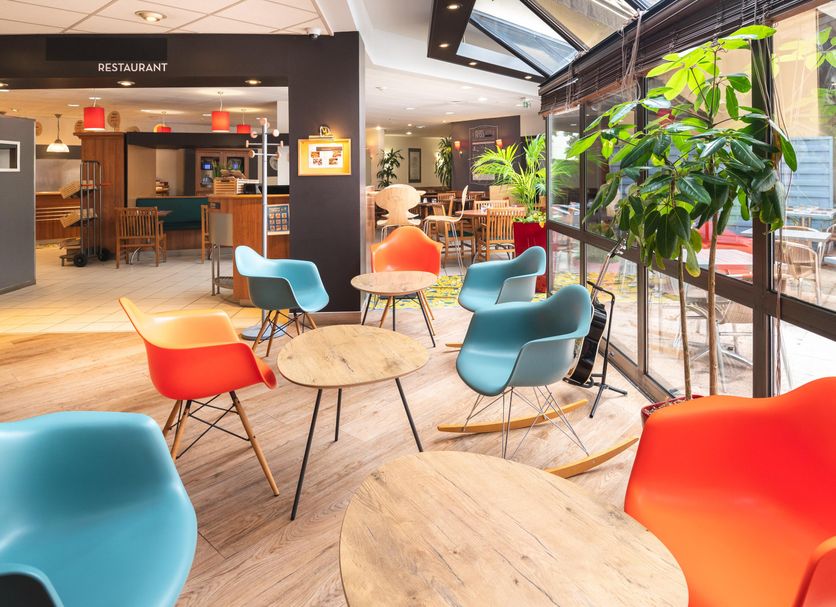 Colorful lounge seating at B&B HOTEL Rouen Centre Rive Droite in Rouen, beside the restaurant