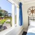 Provincetown Inn room with bed beside a window overlooking the garden in Provincetown