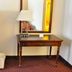 Avalon Inn in Sandusky guest room with TV cabinet, writing desk, lamp and mirror
