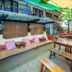 Lazy Dog Bed & Breakfast in Boracay courtyard dining area with wooden tables, benches, and colorful shade canopy
