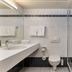 flexymotel Buchs bathroom with sink, toilet, shower, towels and tiled walls
