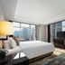 Huihao Hotel Wuhan guest room with city skyline views, bed, TV, and seating area