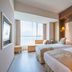 Zhehai Hotel Ningbo guest room with two beds and a bright window view in Ningbo