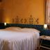 Agriturismo Podere Pratovecchio bedroom in Montefollonico with wrought-iron headboard and wardrobe