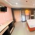 Aa Pattaya Ville in Pattaya: modern guest room with king bed, desk, TV, and ensuite area