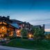 Waldorf Astoria Park City exterior at dusk with mountain setting and glowing lodge-style entrance