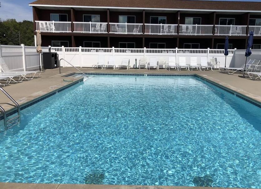 Nader's Motel & Suites in Ludington outdoor pool with lounge chairs and motel balcony