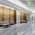 Huiwen Hotel in Shijiazhuang lobby with marble floors, gold partitions, seating, and a glass ceiling feature