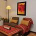 Rio Arriba Suites Apartments y Resto in Bella Vista, cozy seating area with woven textiles and floor lamp