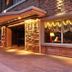 Austral Bahia Blanca Hotel in Bahía Blanca, stone facade entrance with warm exterior lighting at dusk