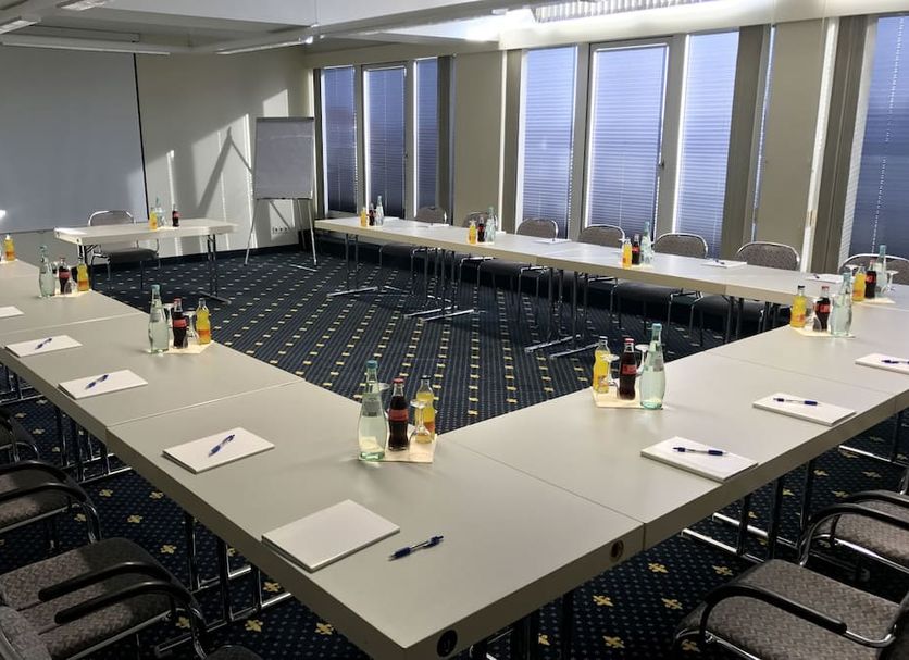 Karaman Group Hotel in Bad Nenndorf meeting room with U-shaped conference table and large windows