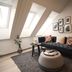 Home Again Apartments Nygata 1 in Stavanger with slanted skylight windows and a cozy seating area