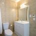 Finns Paekakariki bathroom with shower, toilet, sink and mirror in Paekakariki