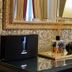 Palazzo Monga Boutique Guesthouse in Verona, ornate lobby console with mirror, lamp, decor and glass surface
