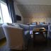 Örserumsbrunn Gestgifveri & Konferens in Gränna: cozy room with two armchairs facing twin beds