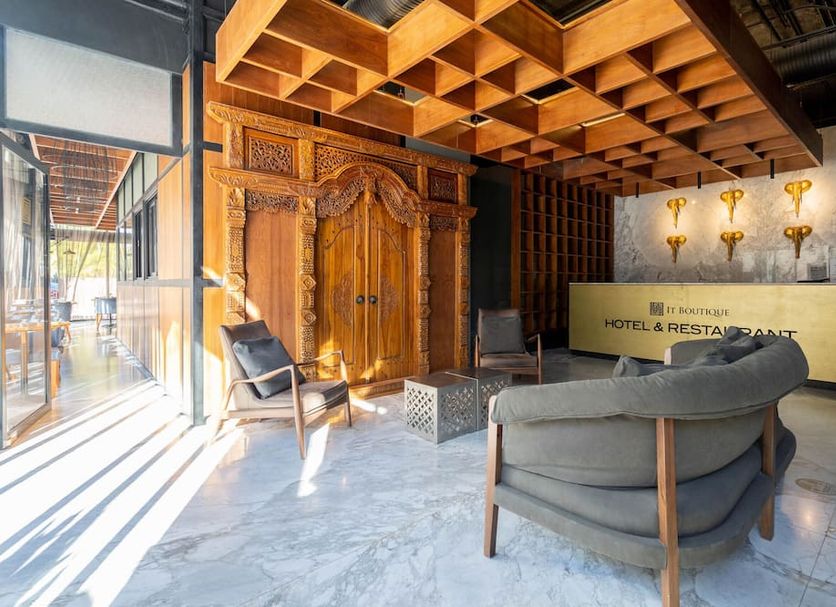 IT Boutique Hotel & Restaurant lobby in Playa del Carmen with carved wood doors and lounge seating